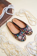Stepellas black juttis featuring intricate multi-color mandala floral hand embroidery and sequin accents.