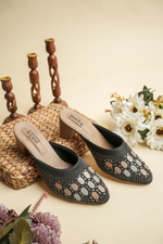 Luxury Stepellas black pointed-toe heels with shimmering silver and gold Siroski stone patterns.