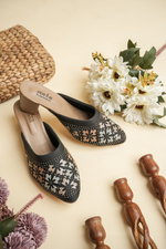 Luxury Stepellas black pointed-toe heels with shimmering geometric Siroski stone patterns.