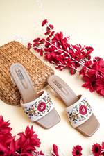 Stepellas white square-toe block heels with vibrant red flower embroidery and clear heels for wedding wear.