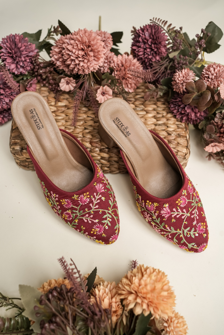 Traditional Stepellas maroon wedding mules featuring vibrant floral threadwork and cushioned soles.