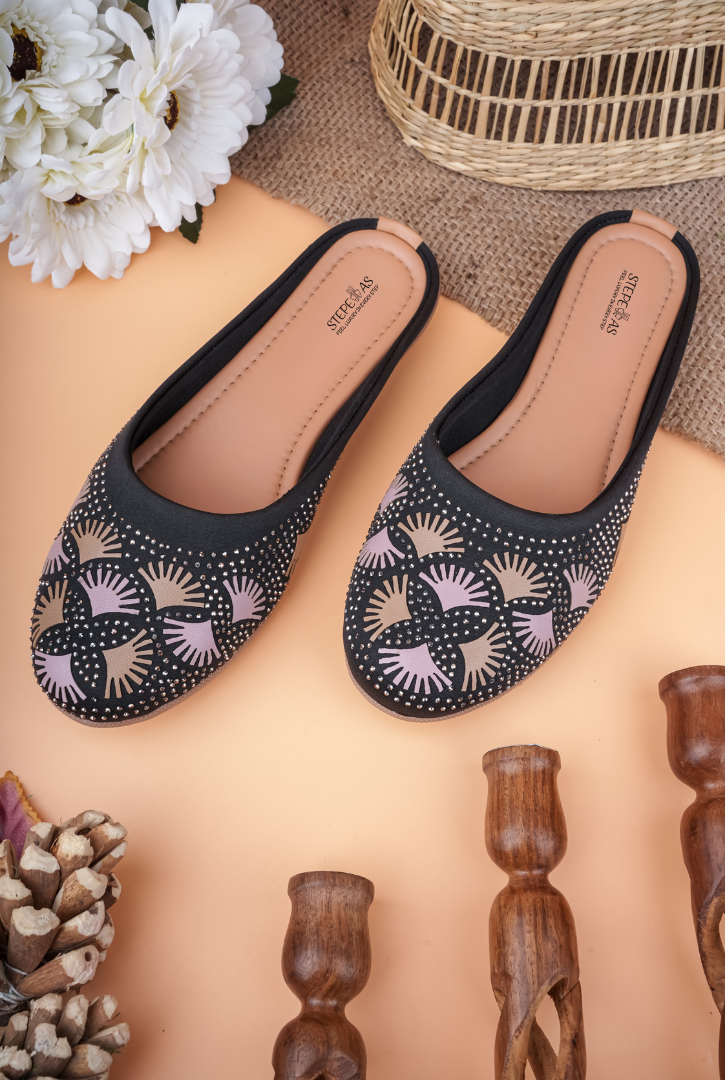A pair of black Stepellas mules with pink embroidery and silver stone embellishments.