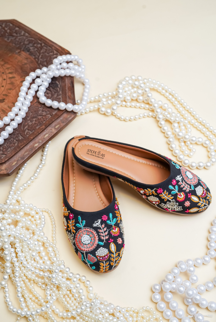 Designer Stepellas black juttis with intricate multi-color mandala floral embroidery and cushioned soles.