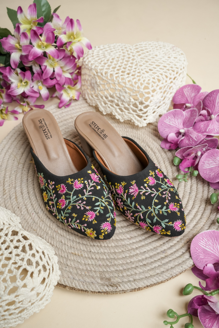Stepellas black block heels with vibrant multi-color floral embroidery and pearl accents.