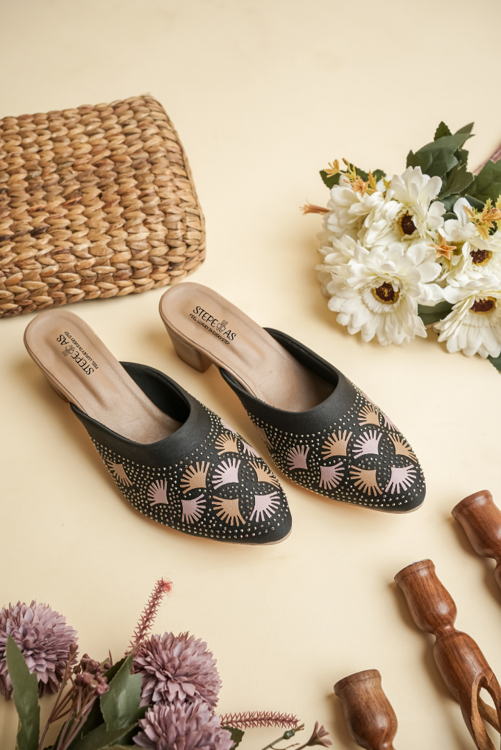 Stepellas black pointed-toe heels featuring a decorative round Siroski stone pattern and silver embellishments.