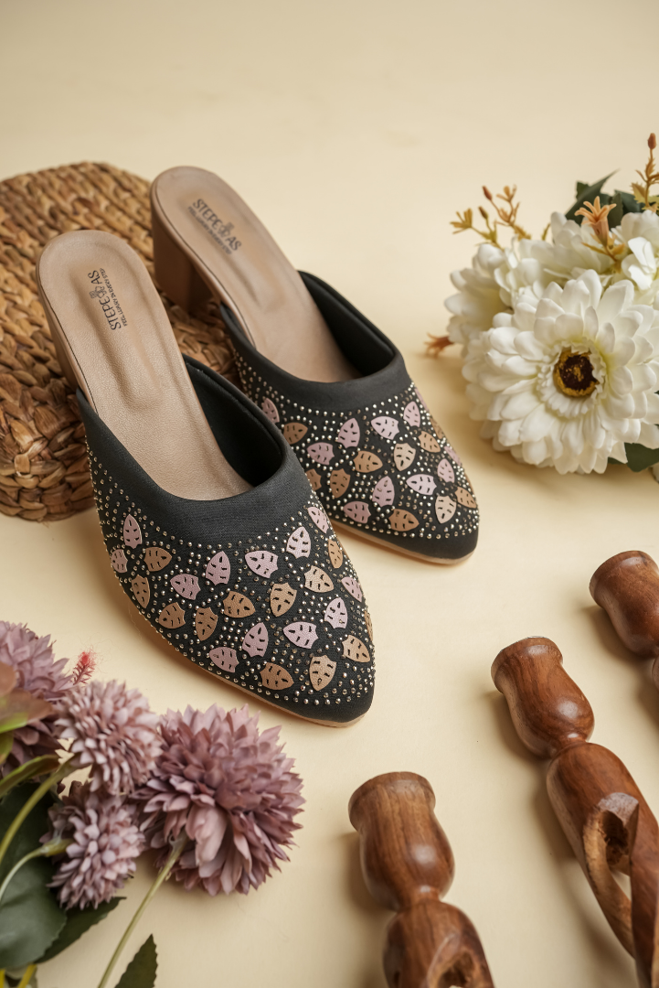 Stepellas black ethnic heels adorned with rose-gold and champagne-colored leaf-shaped stone patterns.
