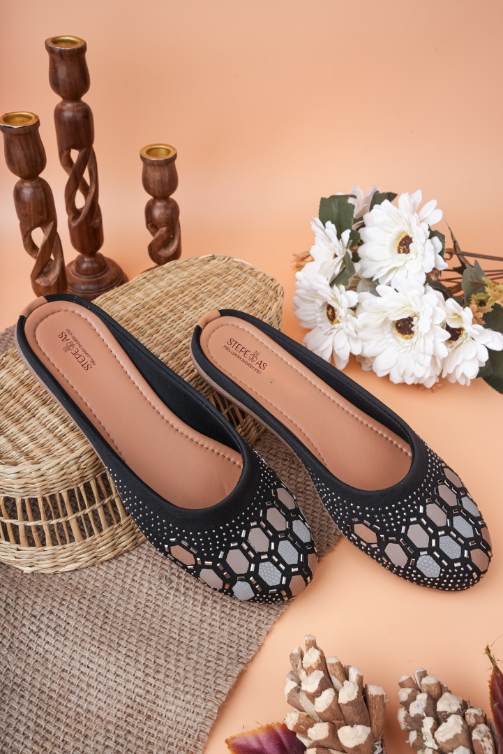 Stepellas black juttis featuring a modern geometric hexagon pattern created with shimmering Siroski stones.