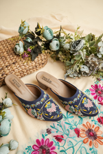 Detailed close-up of the intricate pink floral and golden vine embroidery on Stepellas royal blue heels.