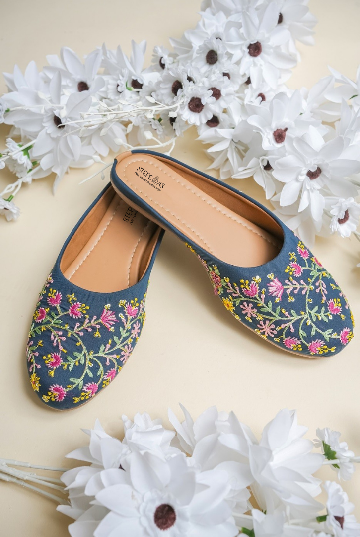 Stepellas blue pointed-toe block heels with intricate handcrafted pink floral vine embroidery.