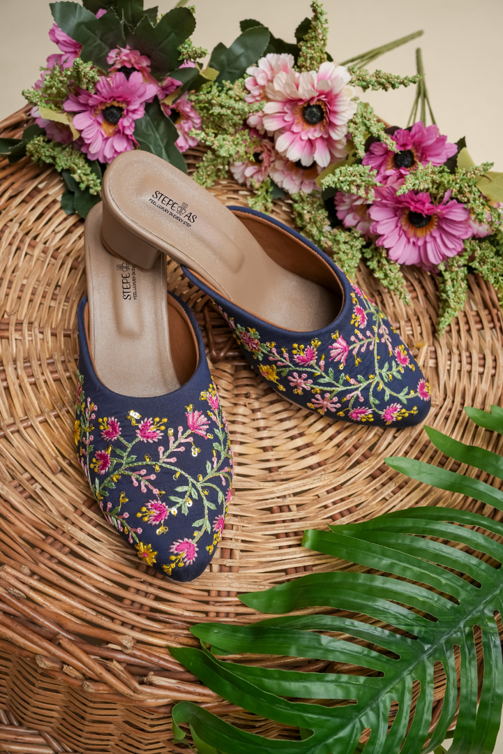 Stepellas navy blue block heels featuring vibrant pink and yellow floral vine (vel) embroidery.