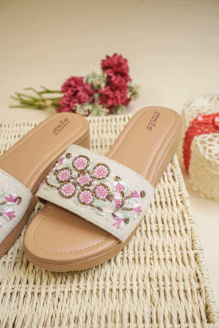 Elegant Stepellas beaded embroidery platform heels displayed with festive red flowers.