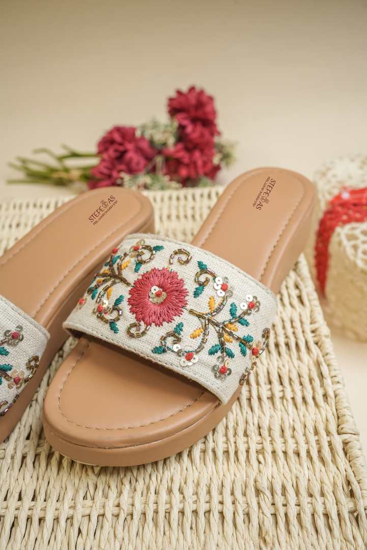 Elegant Stepellas flower work platform heels displayed on a woven basket with red floral accents.