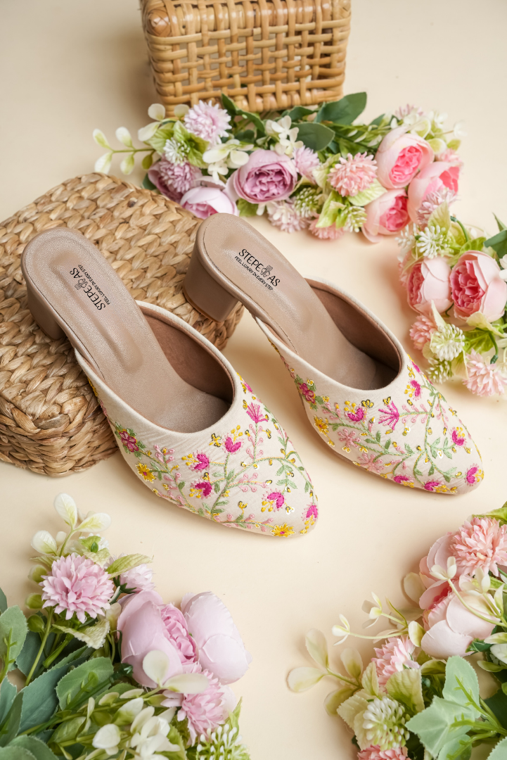 Stepellas cream wedding block heels featuring intricate pink and yellow floral vine embroidery with gold sequins.