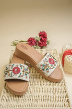 Stepellas cream platform sandals featuring vibrant pink floral embroidery and shimmering beadwork.