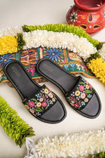 Branded Stepellas black flat sandals highlighting the soft, padded cushioned footbed for all-day comfort.