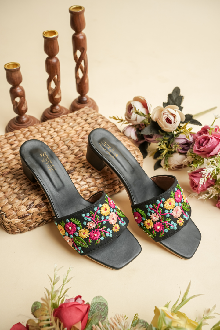 Top view of Stepellas branded black floral heels highlighting the comfortable cushioned footbed and square-toe design.
