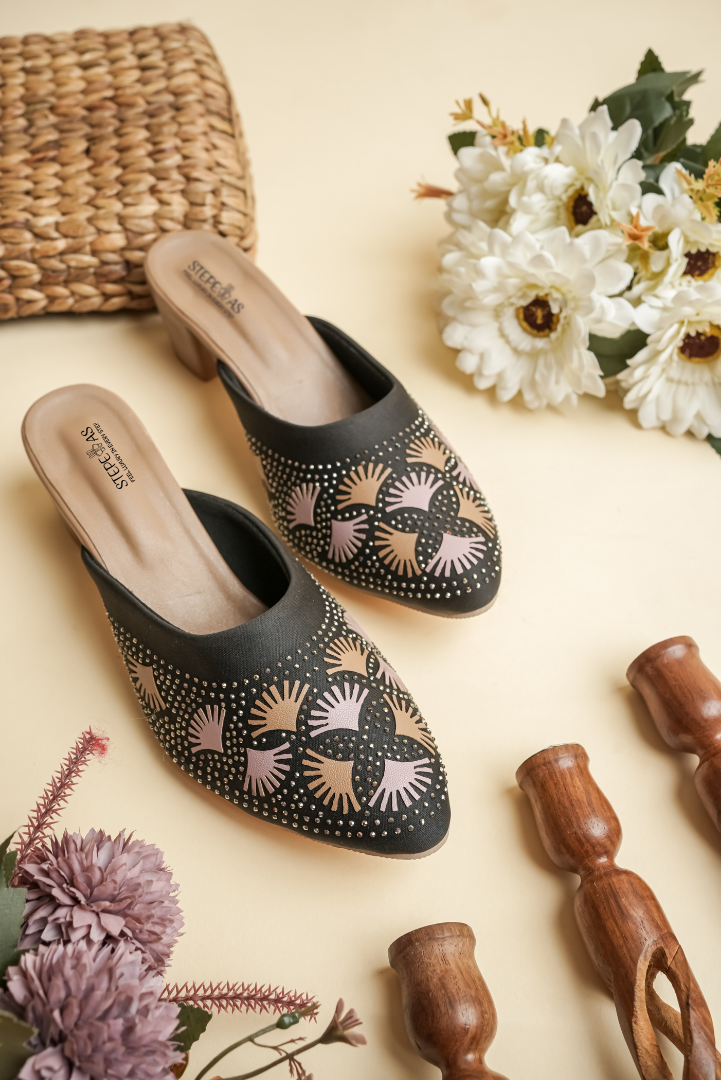 Close-up of Stepellas black heeled mules showing the comfortable padded tan insole and stable block heel.