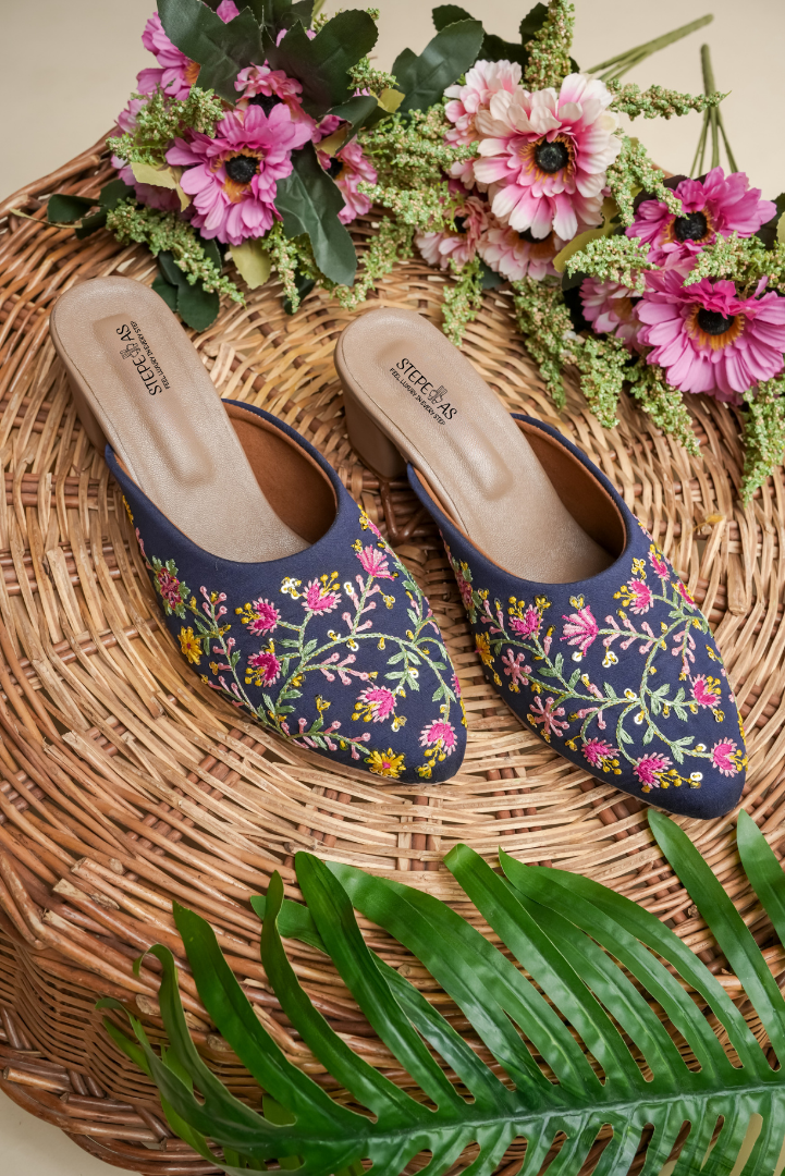Top view of Stepellas branded blue embroidered heels highlighting the soft, padded tan insole for comfort.