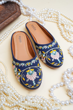 Top view of Stepellas branded blue embroidered juttis highlighting the soft cushioned tan insole.