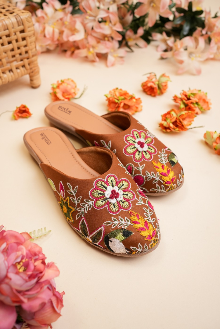 Top view of Stepellas branded coffee color juttis highlighting the soft cushioned tan insole for comfort.