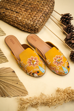 Top view of Stepellas branded mustard yellow juttis highlighting the padded tan insole for wedding comfort.