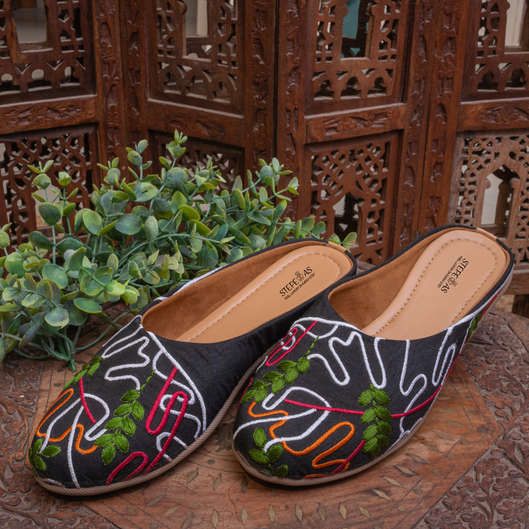 A collection of Stepellas branded black embroidered juttis with cushioned soles for wedding and party wear.