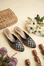 Close-up of Stepellas black heeled mules highlighting the comfortable padded insole and intricate stone detailing.