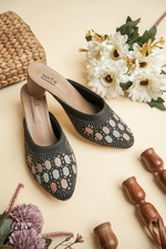 Elegant Stepellas branded black Siroski work heels styled with festive floral decor for wedding fashion.