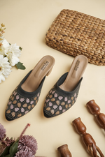 Stepellas luxury black heeled mules with intricate multicolored ethnic embroidery and closed-toe design.