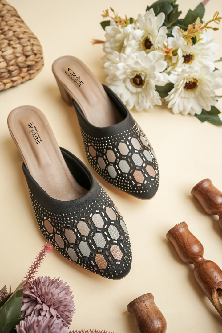 Side view of Stepellas black ethnic heeled mules showing the stable block heel and cushioned footbed