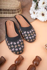 Detailed close-up of the champagne and silver-toned Siroski stone work on Stepellas black ethnic footwear.