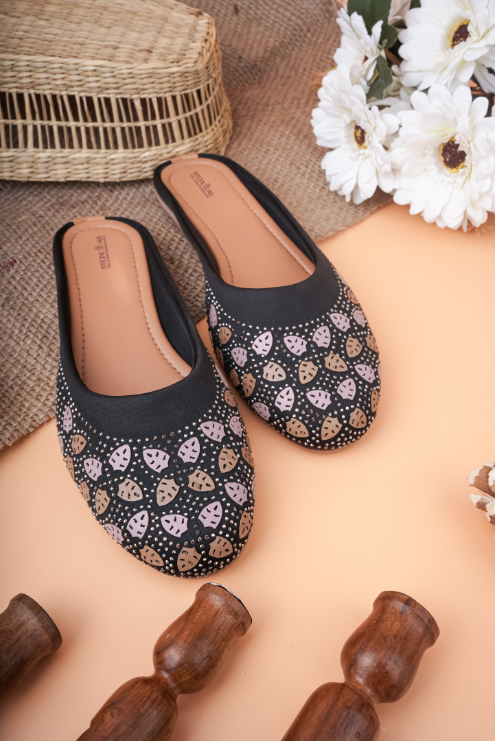 Detailed close-up of the champagne and silver-toned Siroski stone work on Stepellas black ethnic footwear.