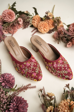 Intricate hand-embroidered floral patterns on Stepellas maroon ethnic footwear with comfortable block heels.