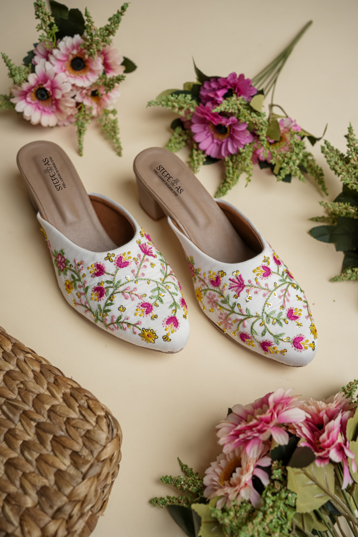 Close-up of Stepellas designer heels highlighting the intricate multi-color threadwork and cushioned tan insole.