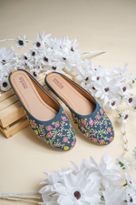 Stepellas maroon ethnic juttis featuring vibrant pink and yellow floral vine embroidery with green threadwork.