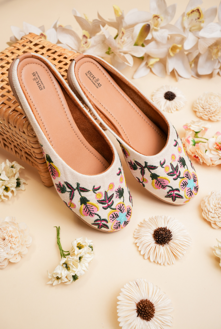 Off white floral embroidered women juttis by Stepellas handcrafted ethnic footwear