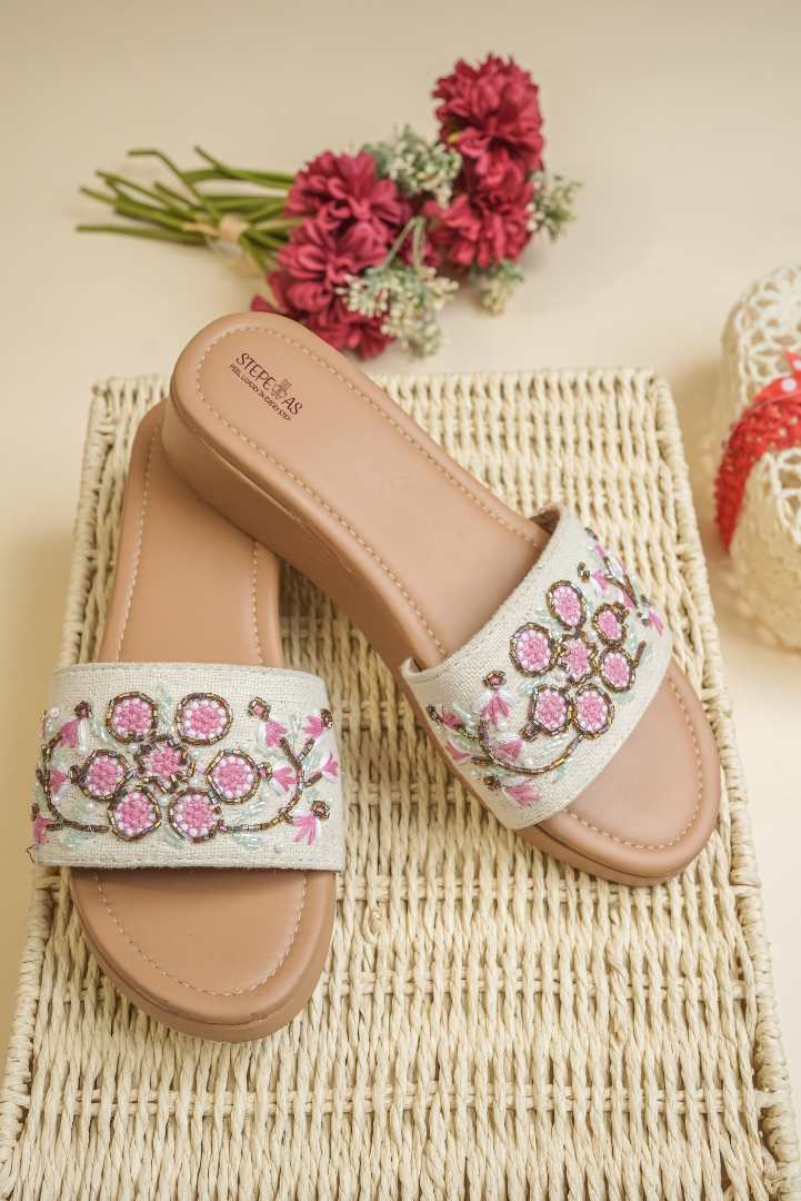 Stepellas cream platform sandals with intricate pink and white floral beadwork and gold sequins.