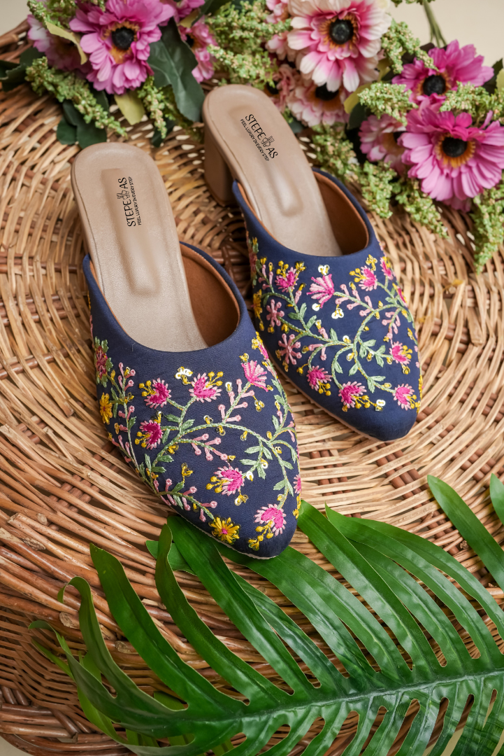 Designer Stepellas royal blue heels with a circular pink floral motif and golden scalloped threadwork.