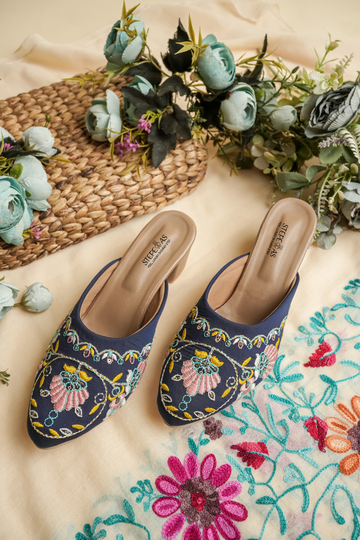 Stepellas royal blue block heels featuring a circular floral pink and green embroidery design.