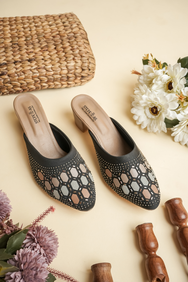 Detailed close-up of the intricate Siroski stone embellishments on Stepellas handcrafted black designer heels.