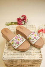 Designer Stepellas tan platform sandals with white straps and intricate pink and yellow floral beadwork.