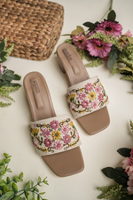 Close-up of Stepellas branded ethnic footwear showing high-quality handcrafted floral patterns.