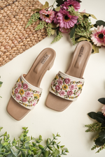 white Stepellas flat mules with grey floral embroidery and silver stud details.