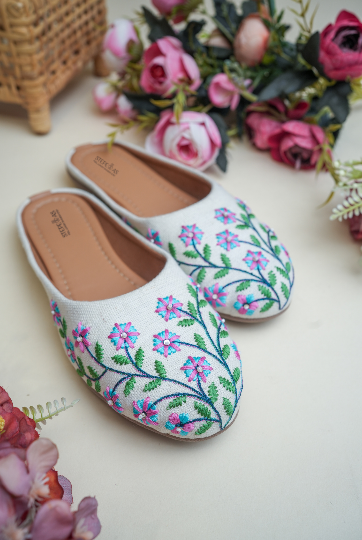 White floral embroidered women juttis for festive and wedding wear