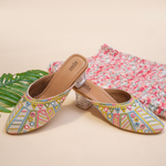 Elegant Stepellas white foil mirror work heels styled with festive floral decor for wedding and party wear.