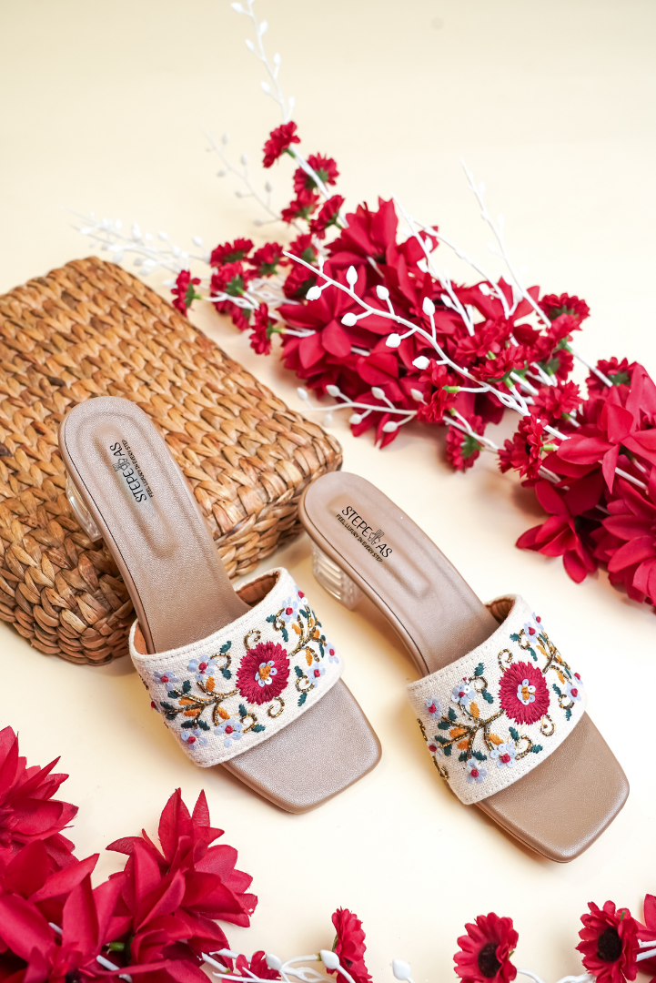Stepellas white square-toe block heels with vibrant red flower embroidery and clear heels for wedding wear.